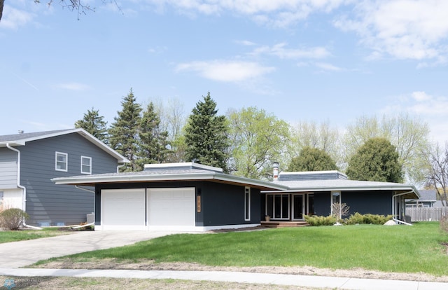 130 Woodcrest Dr N, Fargo, ND 58102 - view of front of home featuring a garage, concrete driveway, and a front lawn