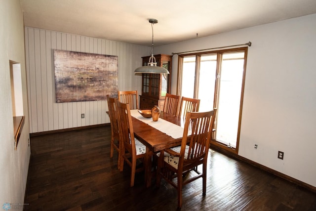 130 Woodcrest Dr N, Fargo, ND 58102 - dining area featuring baseboards, plenty of natural light, dark wood finished floors, and wood walls
