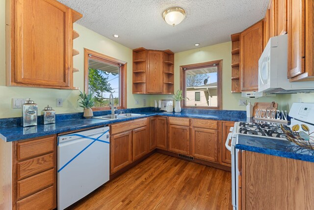 kitchen with open shelves, white appliances, a sink, dark wood-style flooring, and plenty of natural light