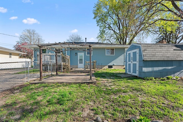rear view of house featuring a storage shed, a pergola, an outdoor structure, a patio, and a deck