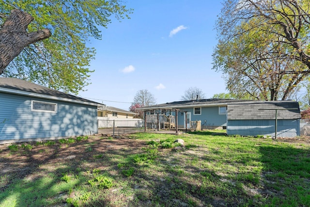 back of house with a storage unit and an outbuilding