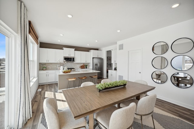 dining room featuring light wood-style floors and recessed lighting