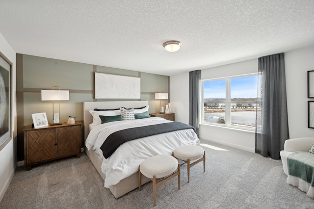 carpeted bedroom featuring baseboards and a textured ceiling