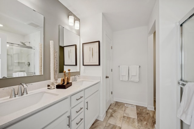 full bathroom featuring a shower stall, marble look tile flooring, double vanity, and baseboards