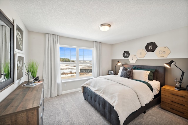 carpeted bedroom with a textured ceiling and baseboards