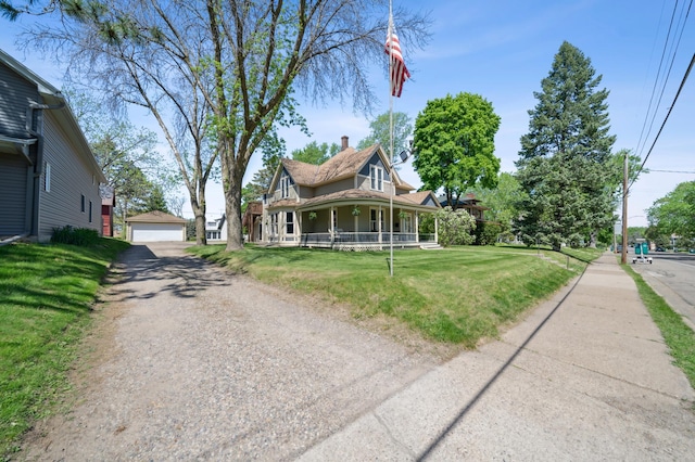 1112 4th St S, Stillwater, MN 55082 - view of front facade featuring a porch, an outdoor structure, a chimney, a front lawn, and a detached garage