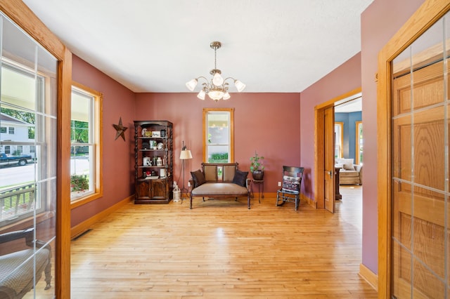 1112 4th St S, Stillwater, MN 55082 - living area with a chandelier, light wood-style floors, and baseboards