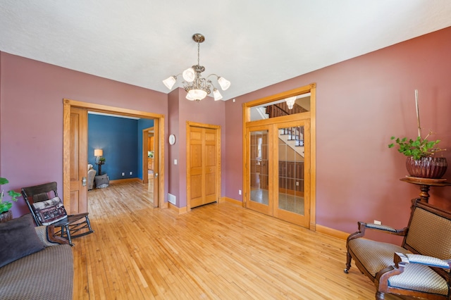 1112 4th St S, Stillwater, MN 55082 - sitting room with a chandelier, light wood-style flooring, baseboards, and french doors