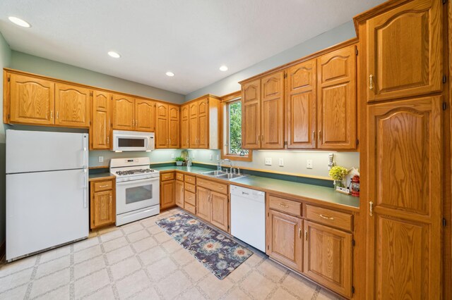 1112 4th St S, Stillwater, MN 55082 - kitchen with white appliances, a sink, light flooring, brown cabinetry, and recessed lighting