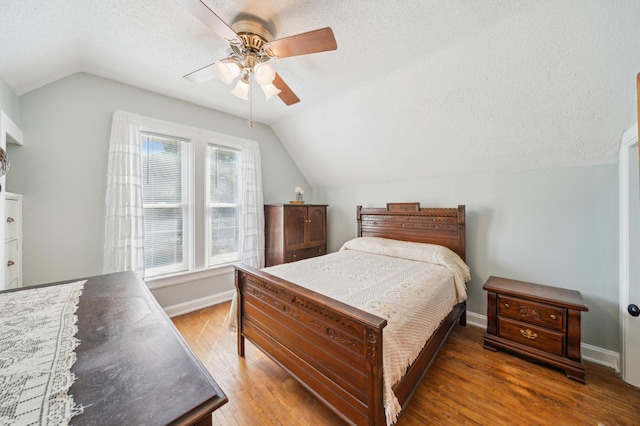 1112 4th St S, Stillwater, MN 55082 - bedroom featuring vaulted ceiling, a textured ceiling, wood finished floors, baseboards, and a ceiling fan