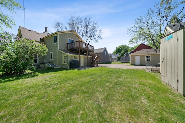 1112 4th St S, Stillwater, MN 55082 - view of green lawn with a deck, stairs, a patio, and driveway