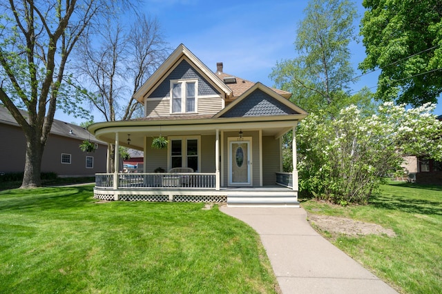 1112 4th St S, Stillwater, MN 55082 - victorian home with a porch, a front lawn, and a chimney