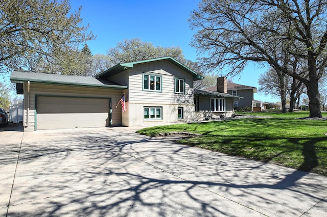 split level home featuring driveway, an attached garage, a front lawn, and brick siding