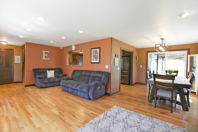 living room with wood finished floors, recessed lighting, and baseboards
