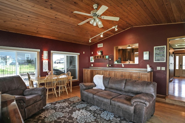 living area with track lighting, wood ceiling, light wood-type flooring, lofted ceiling, and ceiling fan