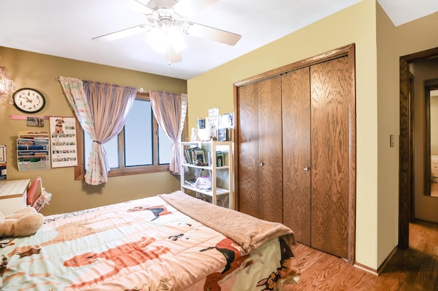 bedroom with wood finished floors, a closet, and ceiling fan