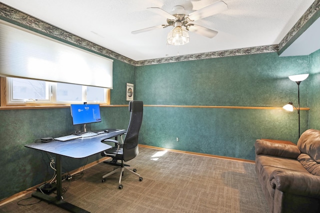 office space featuring a ceiling fan and baseboards