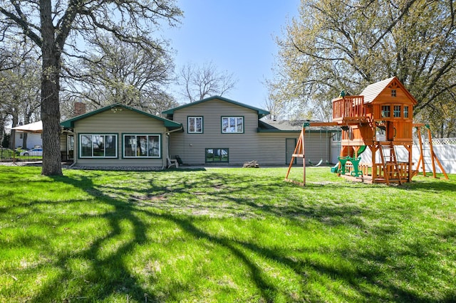 rear view of house featuring a playground