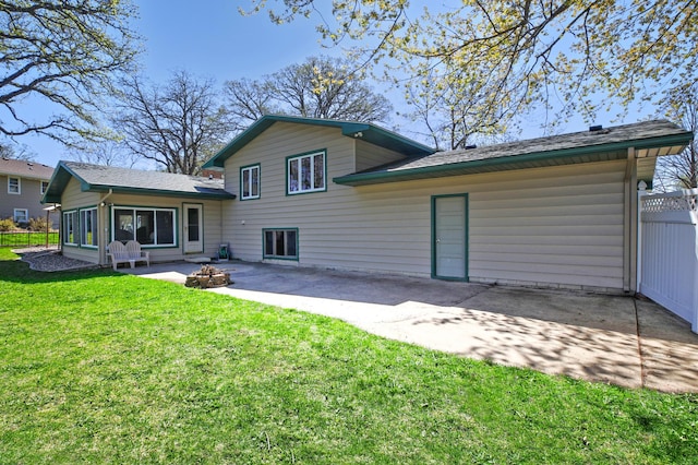 back of property featuring a patio area and a fire pit
