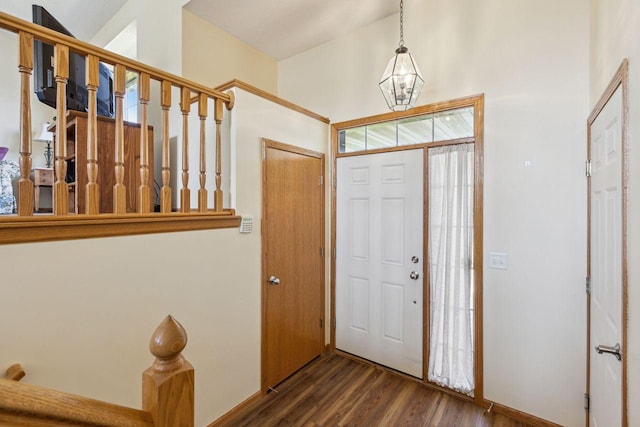 foyer featuring wood finished floors and a chandelier