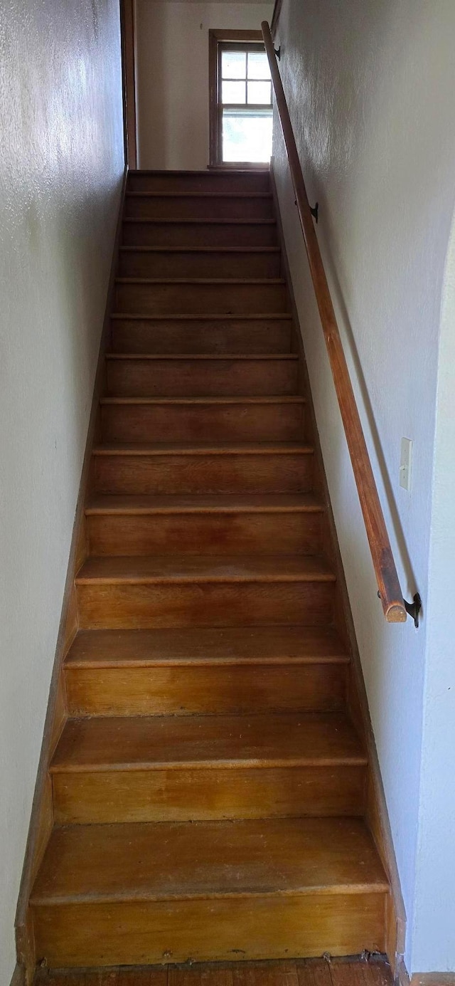stairs featuring hardwood / wood-style flooring