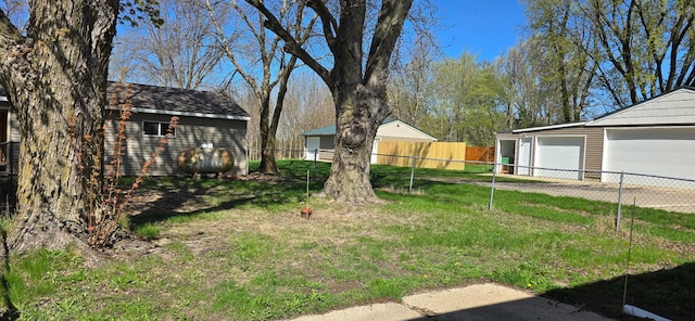 view of yard featuring an outbuilding and a detached garage