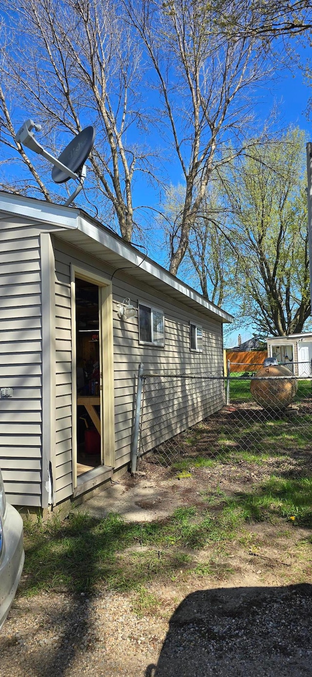 view of side of home with fence