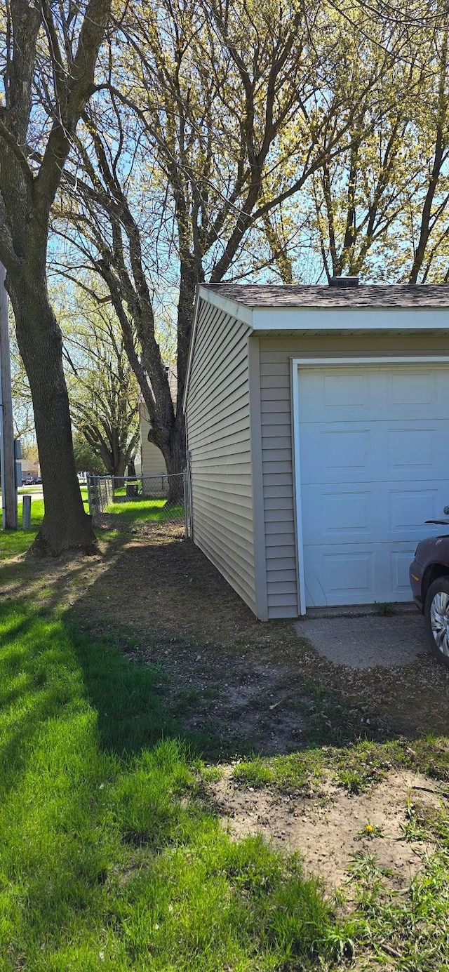 detached garage featuring fence