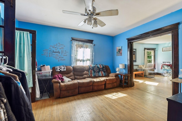 living room with ceiling fan and hardwood / wood-style flooring