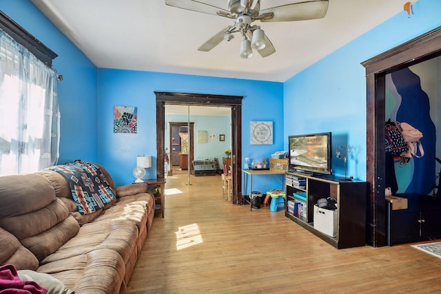 living room with wood finished floors and ceiling fan