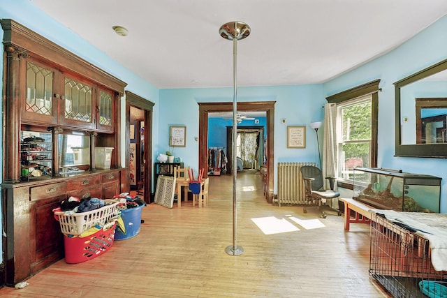 interior space featuring radiator and light wood finished floors