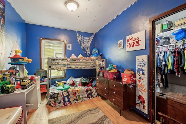 bedroom with a closet and hardwood / wood-style floors