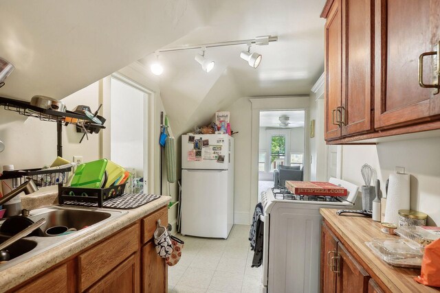 clothes washing area with rail lighting, light floors, and a ceiling fan