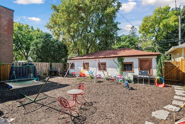 rear view of property with a fenced backyard and stucco siding
