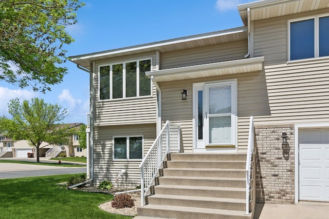 view of exterior entry with brick siding