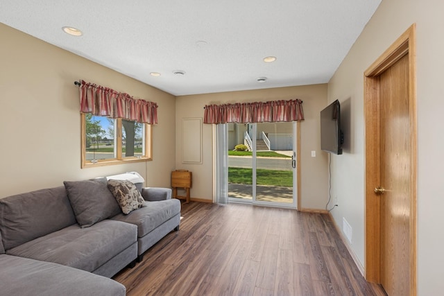 living room featuring wood finished floors, baseboards, and recessed lighting