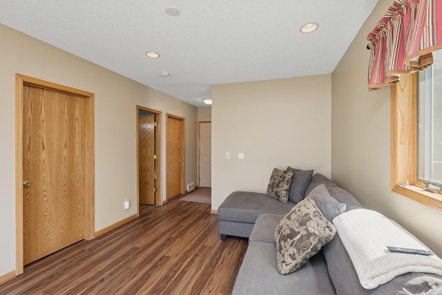 living area with wood finished floors, recessed lighting, and baseboards