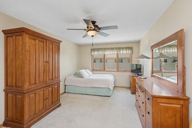 bedroom with light carpet, baseboards, and ceiling fan