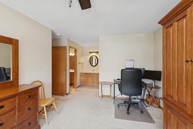 office space featuring light colored carpet and ceiling fan