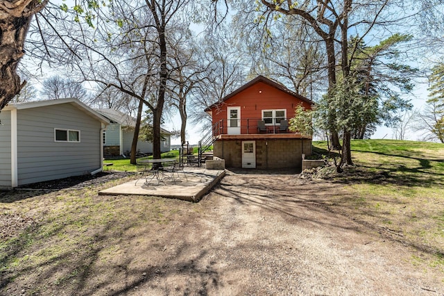 23711 Clarissa Haven Dr, Girard Twp, MN 56551 - rear view of property with a patio and a wooden deck