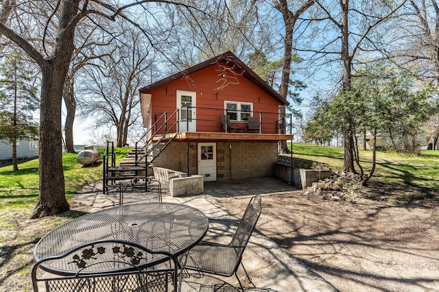 23711 Clarissa Haven Dr, Girard Twp, MN 56551 - rear view of house with a patio area, stairway, and a wooden deck