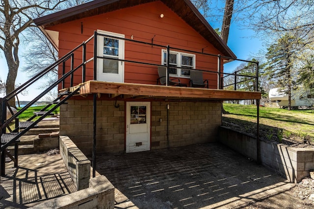 23711 Clarissa Haven Dr, Girard Twp, MN 56551 - rear view of house featuring stairway, a patio area, and a wooden deck