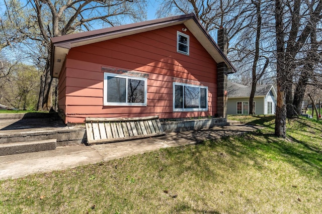 23711 Clarissa Haven Dr, Girard Twp, MN 56551 - view of side of property featuring a yard and a chimney