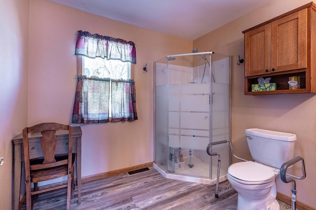 23711 Clarissa Haven Dr, Girard Twp, MN 56551 - full bathroom with wood finished floors, a stall shower, toilet, and baseboards