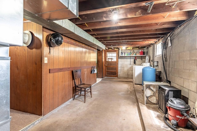 23711 Clarissa Haven Dr, Girard Twp, MN 56551 - basement featuring washer and clothes dryer, wood walls, and a water pressure tank