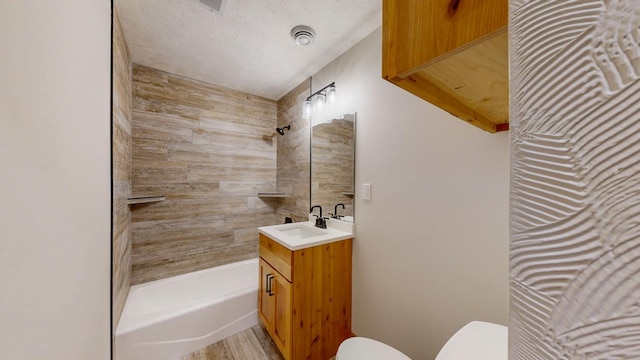 bathroom featuring toilet, wood finished floors, and vanity