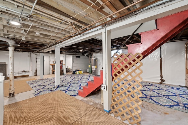 unfinished basement featuring water heater and stairs