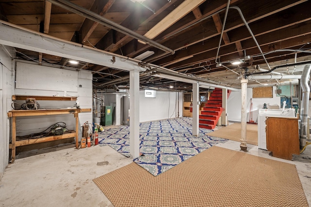 below grade area featuring washer / dryer, stairway, and water heater