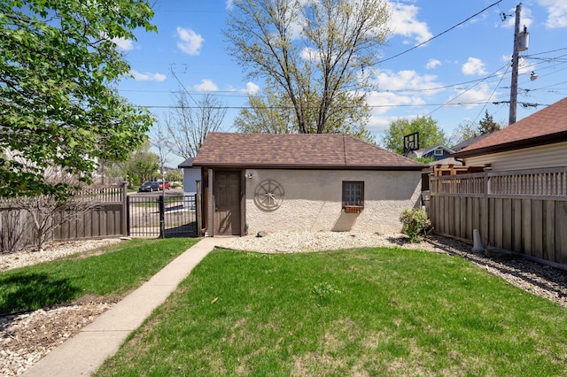 view of yard featuring an outbuilding and a gate