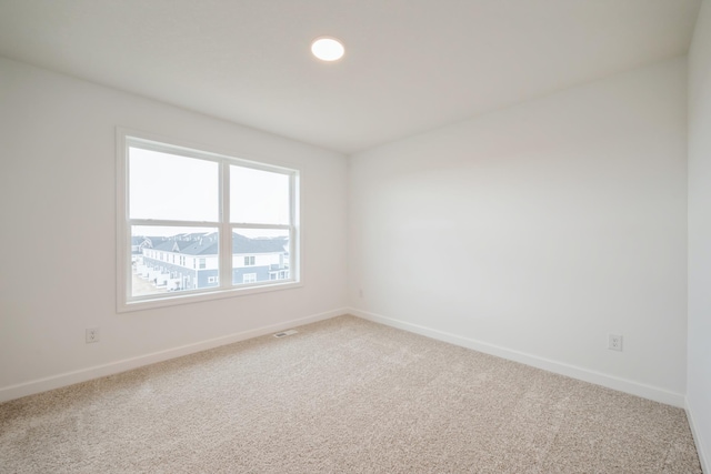 empty room with carpet and baseboards